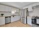 Updated kitchen featuring stainless steel appliances, white subway tile backsplash, and wood countertops at 12022 W Dakota Dr, Lakewood, CO 80228