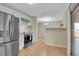 Modern kitchen with white cabinets, stainless steel appliances, and hardwood floors at 12022 W Dakota Dr, Lakewood, CO 80228