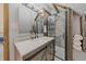 Stylish bathroom with a rustic vanity, quartz countertop, framed mirror and tile shower with wood frame at 80 Castlewood Ct, Evergreen, CO 80439