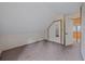 Sloped-ceiling bedroom with neutral carpet, white walls, and a closet featuring a mirror sliding door at 80 Castlewood Ct, Evergreen, CO 80439
