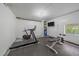 Home gym with exercise equipment and a large window at 80 Castlewood Ct, Evergreen, CO 80439