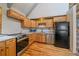 Bright kitchen featuring wood cabinetry, stainless steel appliances, and subway tile backsplash at 80 Castlewood Ct, Evergreen, CO 80439
