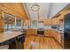 Bright kitchen featuring light wood cabinets, stainless steel appliances, and hardwood floors at 80 Castlewood Ct, Evergreen, CO 80439