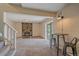 Comfortable living room with stone fireplace, neutral carpet, and access to the outdoors via a sliding glass door at 80 Castlewood Ct, Evergreen, CO 80439