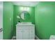 Bright bathroom featuring a white vanity with a round mirror and modern light fixture at 6389 S Ponds Way, Littleton, CO 80123