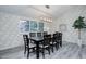 Elegant dining room with a large window, modern light fixture, and stylish decor at 6389 S Ponds Way, Littleton, CO 80123