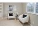 Cozy sitting area with two plush chairs, a small table, and natural light from the window at 6389 S Ponds Way, Littleton, CO 80123