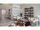 Open living area with unique decor, a cowhide rug, stylish seating, and modern shelving at 6389 S Ponds Way, Littleton, CO 80123