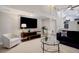 Inviting living room featuring a modern TV console and neutral decor at 6389 S Ponds Way, Littleton, CO 80123