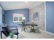 Stylish home office with blue walls, whitewashed brick accent wall, and modern desk setup at 6389 S Ponds Way, Littleton, CO 80123