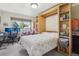Bright bedroom with hide-away bed and built-in shelves near window at 625 S Clinton St # 7A, Denver, CO 80247