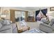 Spacious living room with sliding glass doors, comfortable seating, and natural light at 625 S Clinton St # 7A, Denver, CO 80247