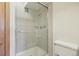 Bathroom shower featuring neutral-toned tiles and glass door at 625 S Clinton St # 7A, Denver, CO 80247