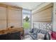 Sunroom with light brick walls and wooden window blinds at 625 S Clinton St # 7A, Denver, CO 80247