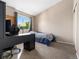 Bright bedroom with a large window, desk, and a view of the yard at 4691 S Fraser Cir # A, Aurora, CO 80015