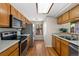 Well-lit kitchen featuring stainless steel appliances and hardwood floors at 4691 S Fraser Cir # A, Aurora, CO 80015