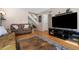 Spacious living room with a large tv and comfortable leather couch at 4691 S Fraser Cir # A, Aurora, CO 80015