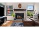Cozy living room featuring a fireplace and a comfortable leather sectional at 4691 S Fraser Cir # A, Aurora, CO 80015