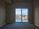 Bedroom with sliding glass doors to balcony with views at 15475 E Andrews Dr # 402, Denver, CO 80239