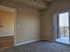 Bedroom with view to adjoining space and sliding glass doors to balcony at 15475 E Andrews Dr # 402, Denver, CO 80239