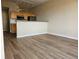 Open floor plan featuring living room with hardwood floors adjacent to the kitchen at 15475 E Andrews Dr # 402, Denver, CO 80239