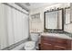 Neat bathroom featuring a shower with a curtain, vanity with mirror, and neutral decor at 4760 S Wadsworth Blvd # K205, Littleton, CO 80123