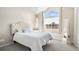 Tranquil bedroom showcasing a large window, vaulted ceiling, and comfortable bed at 4760 S Wadsworth Blvd # K205, Littleton, CO 80123
