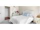 Inviting bedroom featuring plush bedding, vintage dresser, and ample natural light at 4760 S Wadsworth Blvd # K205, Littleton, CO 80123