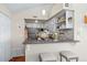 Modern kitchen with stainless appliances, granite countertops, and breakfast bar at 4760 S Wadsworth Blvd # K205, Littleton, CO 80123