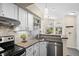 Contemporary kitchen with stainless appliances, tile backsplash, and breakfast bar at 4760 S Wadsworth Blvd # K205, Littleton, CO 80123