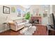 Bright living room featuring a brick fireplace, plush seating, and ample natural light at 4760 S Wadsworth Blvd # K205, Littleton, CO 80123