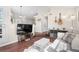 Cozy living room with a large TV, wood floors, and comfortable seating area at 4760 S Wadsworth Blvd # K205, Littleton, CO 80123