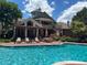 Beautiful community pool with lounge chairs and a pergola-covered patio area at 4760 S Wadsworth Blvd # K205, Littleton, CO 80123