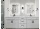 Primary bathroom featuring double sinks, white cabinets and backlit mirrors at 2361 Junegrass Ln, Louisville, CO 80027