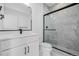 This is a modern bathroom with a shower, white cabinets, and marble walls at 2361 Junegrass Ln, Louisville, CO 80027