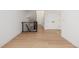 Hallway featuring hardwood floors, a metal railing and white trim at 2361 Junegrass Ln, Louisville, CO 80027