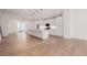 Bright, modern kitchen with large island, pendant lighting, and white cabinetry at 2361 Junegrass Ln, Louisville, CO 80027