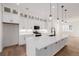 Close up on the well-equipped kitchen with custom cabinetry, stainless appliances, and pendant lights at 2361 Junegrass Ln, Louisville, CO 80027