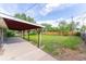 Spacious backyard featuring a covered patio, a large grassy area, and a new wooden fence at 2630 W Asbury Ave, Denver, CO 80219