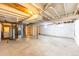 Unfinished basement with concrete floor, white painted walls, and exposed ceiling providing potential for customization at 2630 W Asbury Ave, Denver, CO 80219