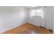 Bedroom featuring hardwood floors, a window with curtains, and a clean, bright space at 2630 W Asbury Ave, Denver, CO 80219