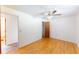 Bright bedroom featuring hardwood floors, a ceiling fan, and a spacious closet at 2630 W Asbury Ave, Denver, CO 80219