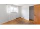Bedroom showcasing a window with curtains and a closet for storage at 2630 W Asbury Ave, Denver, CO 80219