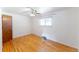 Bedroom featuring hardwood floors, a ceiling fan, and a window that allows natural light at 2630 W Asbury Ave, Denver, CO 80219