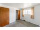 Bedroom showcasing a window with curtains and a closet for storage at 2630 W Asbury Ave, Denver, CO 80219