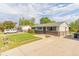 Ranch style home with a green lawn, fenced yard, and spacious driveway for parking at 2630 W Asbury Ave, Denver, CO 80219