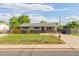 Inviting single-story home featuring lush front yard and a convenient driveway at 2630 W Asbury Ave, Denver, CO 80219