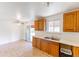 Bright eat-in kitchen with tile flooring, wood cabinets, and convenient sliding patio door at 2630 W Asbury Ave, Denver, CO 80219