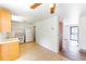 Bright kitchen with tile flooring, wood cabinets, and convenient access to other rooms at 2630 W Asbury Ave, Denver, CO 80219
