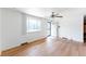 Sunlit living area features beautiful wood floors, large windows, and modern ceiling fan at 2630 W Asbury Ave, Denver, CO 80219